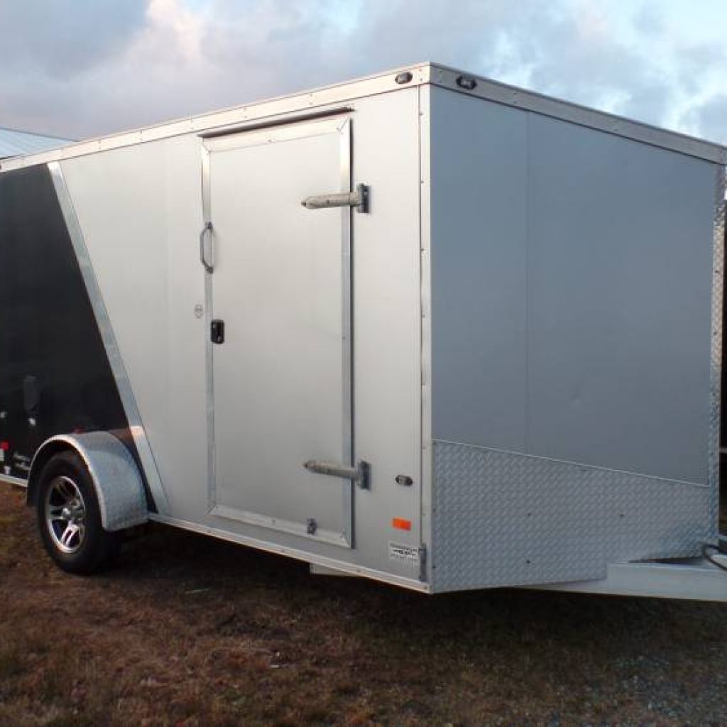 USED, 7X12 V nose enclosed trailer, Aluminum Frame, Ramp Door, Side Door, 3,500 lb. GVWR, Electric Brakes, Aluminum Rims.  e track installed on floor ,set up to carry a motorcycle ( with optional accessories.)