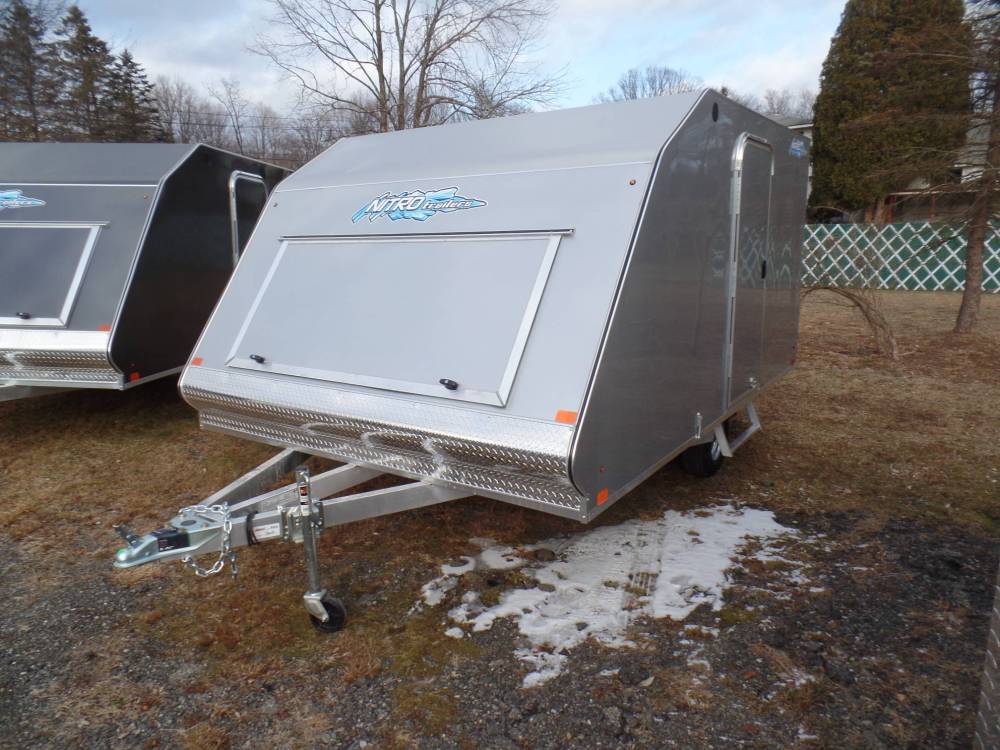 2 place enclosed snowmobile trailer, ramp door, side door, 2,990 lb. GVWR, aluminum frame, galvanized axle. track mats ski guides